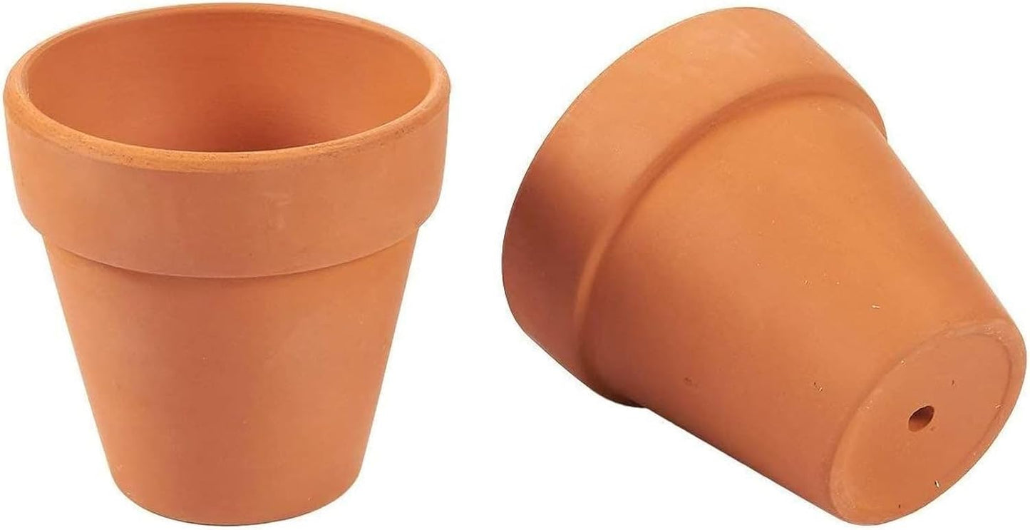 Two small 3.5" terracotta flower pots shown on a plain white background, one upright and one tipped on its side to show the drainage hole.
