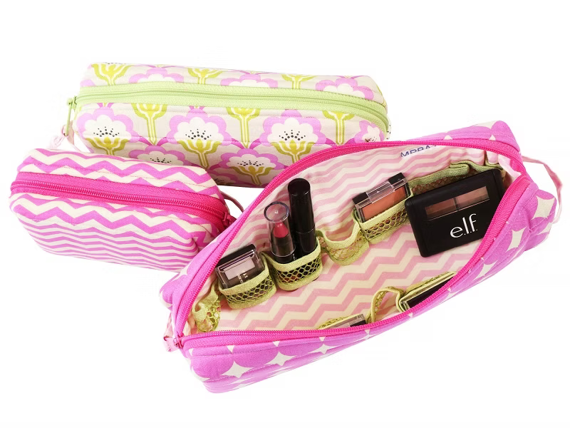Pink makeup bag with cosmetic items on a white background.
Photo by Annie [additional_image_link]