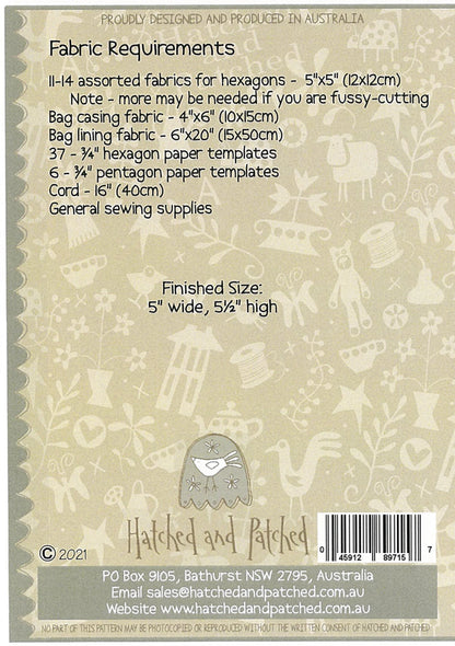 Back of a Hatched and Patched fabric kit packaging card, showing fabric requirements, finished size, a barcode, and product details on a beige patterned background.
Photo by Hatched and Patched [additional_image_link]