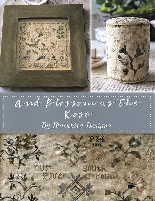 A collage-style product image for a cross-stitch pattern titled "And Blossom as The Rose" by Blackbird Designs. It shows a framed finished cross-stitch piece with birds and branches, a matching fabric-covered cylindrical container, and a close-up of the stitched floral and text design on beige fabric.
Photo by Blackbird Designs [image_link]