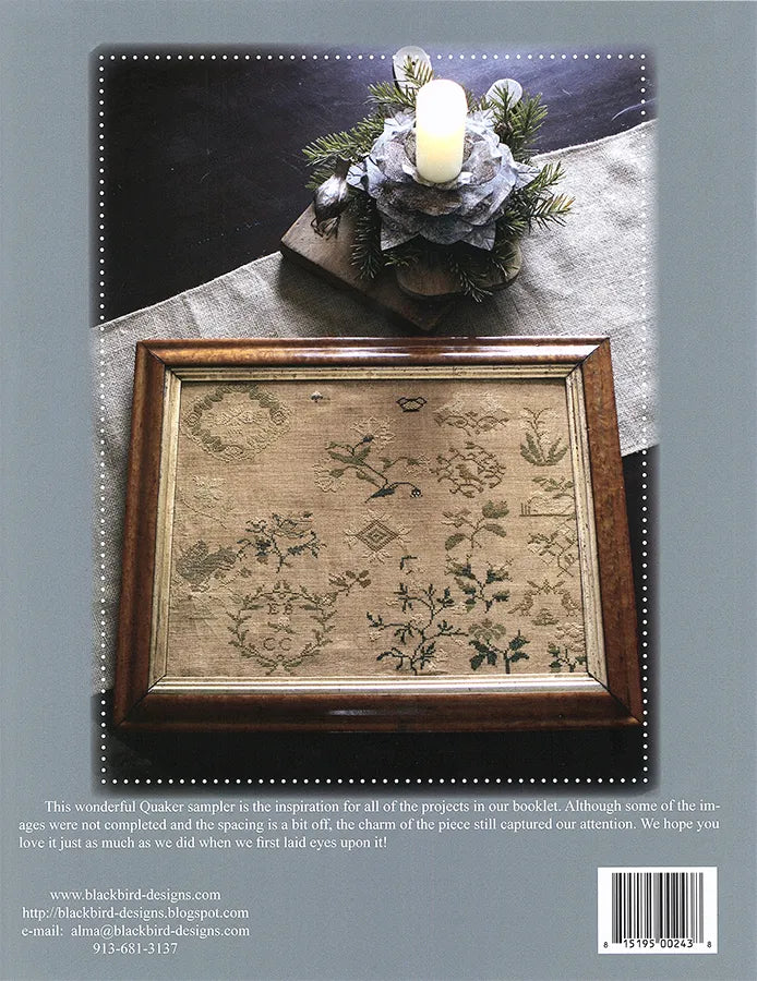 Back cover of a Blackbird Designs quilt pattern booklet, featuring a framed floral sampler design with a candle and linen cloth above it, plus product information and a barcode at the bottom.
Photo by Blackbird Designs [additional_image_link]