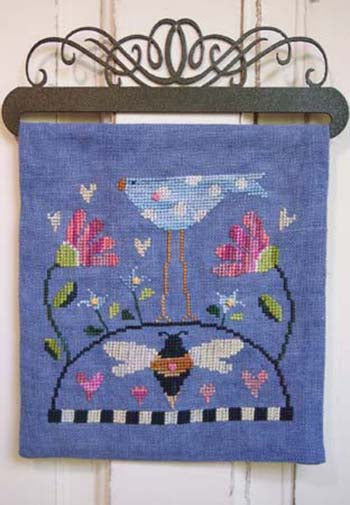 Cross stitch panel with a bird, flower and a bee design on a wooden surface.
Photo by SamSarah Studio Designs [image_link]