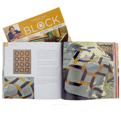 An open quilting book spread showing quilt patterns and finished quilt designs, with a matching book cover visible behind it on a white background.
[additional_image_link]