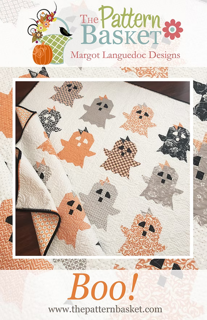 Promotional graphic for a quilt pattern featuring a white quilt with ghost appliqués in orange, gray, and black. The top and bottom text reads 'The Pattern Basket' and 'Boo!'.
Photo by ThePatternBasket.com [image_link]