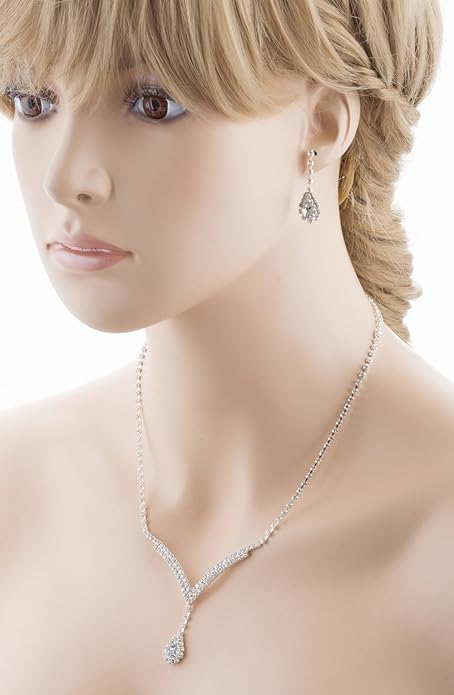 Close-up of a woman wearing a diamond necklace and earrings on a white background
[additional_image_link]
