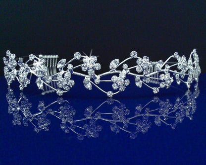Silver tiara with floral design on a reflective blue surface
[image_link]