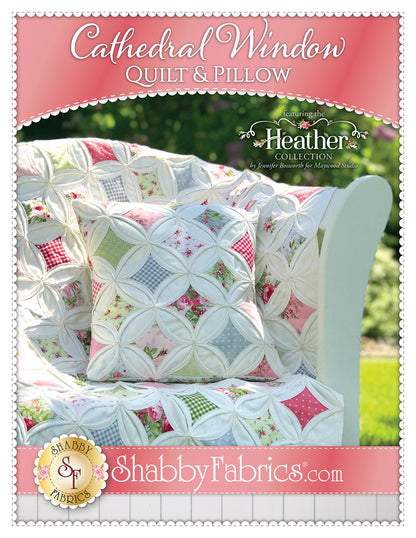 A quilt and pillow set featuring a cathedral window pattern with multicolored patches, showcased on a white chair outdoors. The product image includes the brand name 'Shabby Fabrics' and the website address.
Photo by Shannon Fabrics [image_link]