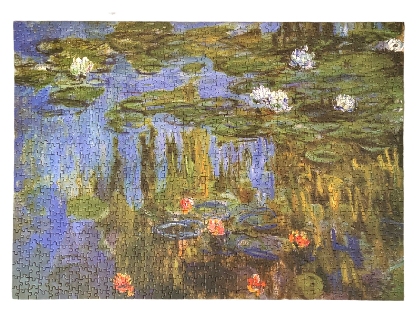 A jigsaw puzzle box featuring Claude Monet's 'Water Lilies' painting. The box is green with a gold foiled quote, a magnetic closure, and the Monarque brand logo.
Photo by Karen King [additional_image_link]