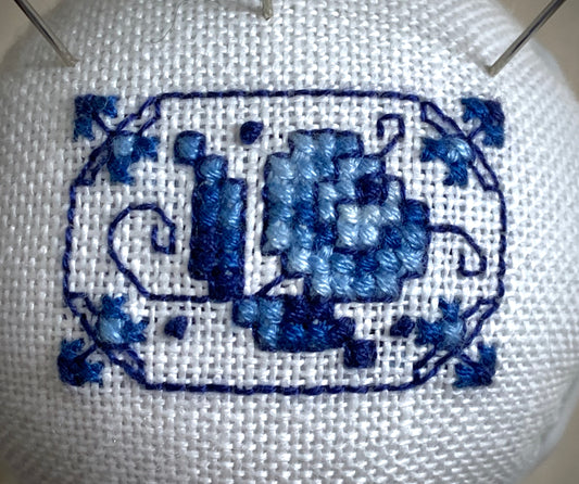 Hand stitched Delft pincushion on white linen with a Vintage Blue Danube Double Egg Cup from Japan, embroidered in blue and white colors.
Photos by The Surgeon's Knots [image_link]