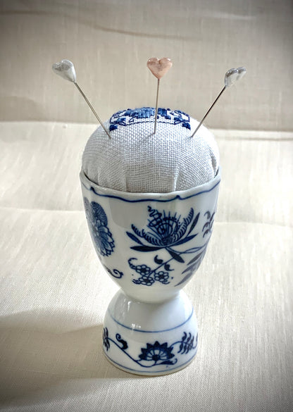 Hand stitched Delft pincushion on white linen with a Vintage Blue Danube Double Egg Cup from Japan, embroidered in blue and white colors.
Photos by The Surgeon's Knots [additional_image_link]