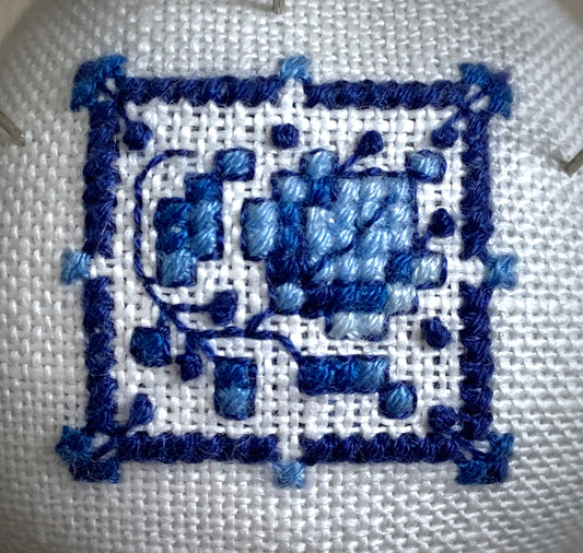 Hand stitched Delft pincushion in a vintage blue Danube double egg cup on white linen, with a signature pattern by Blue Danube in Japan.
Photos by The Surgeon's Knots [image_link]