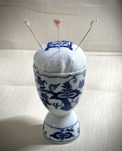 Hand stitched Delft pincushion in a vintage blue Danube double egg cup on white linen, with a signature pattern by Blue Danube in Japan.
Photos by The Surgeon's Knots [additional_image_link]
