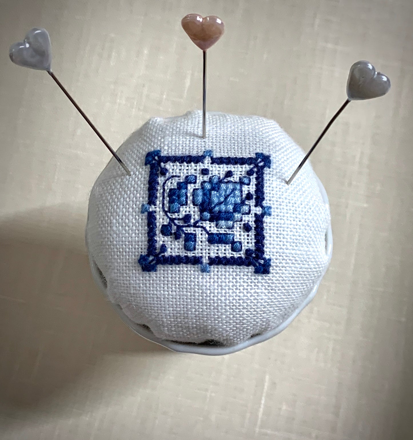 Hand stitched Delft pincushion in a vintage blue Danube double egg cup on white linen, with a signature pattern by Blue Danube in Japan.
Photos by The Surgeon's Knots [additional_image_link]