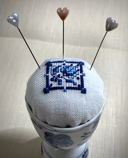 Hand stitched Delft pincushion in a vintage blue Danube double egg cup on white linen, with a signature pattern by Blue Danube in Japan.
Photos by The Surgeon's Knots [additional_image_link]