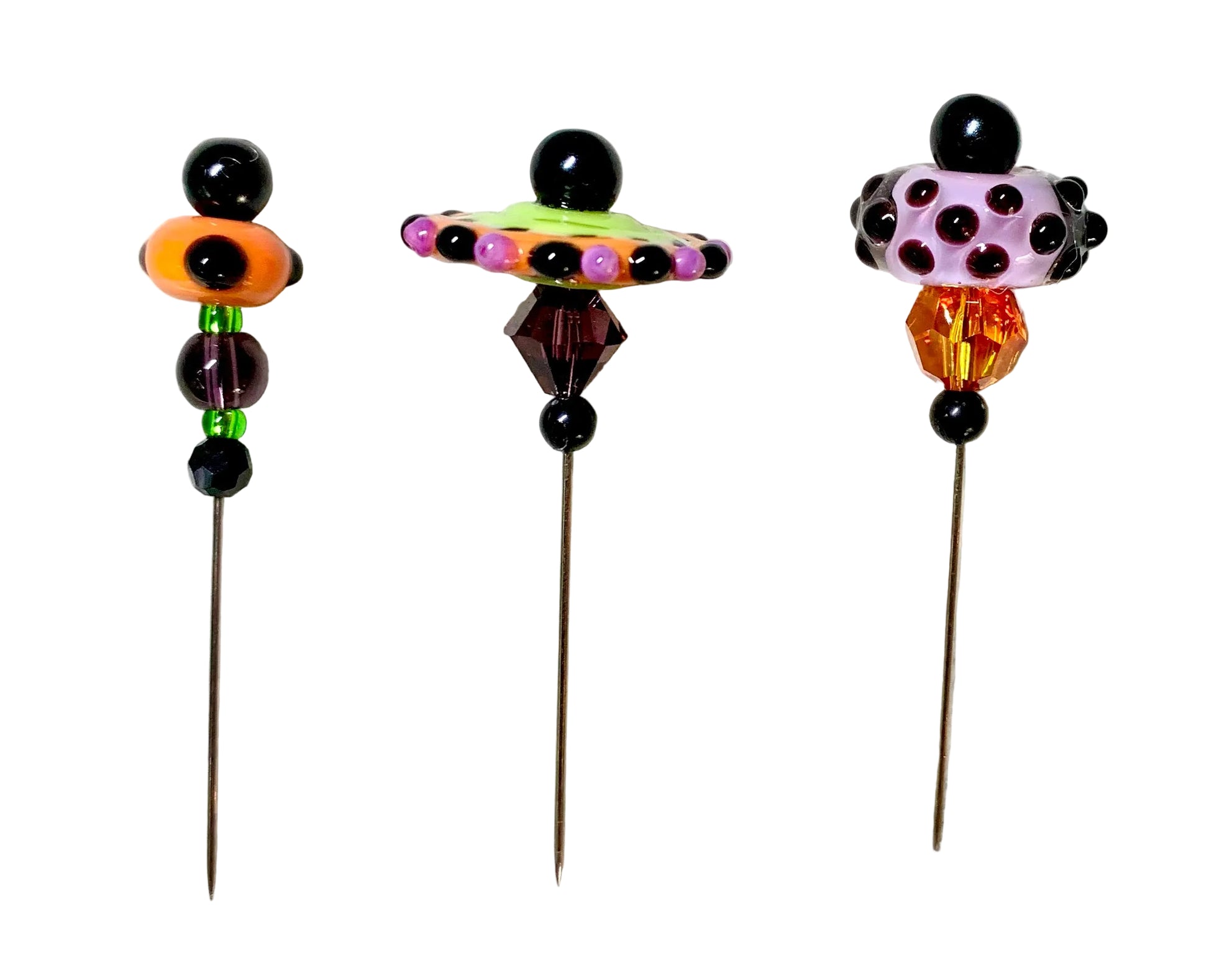 Three colorful beaded pins with long metal needles, displayed on a white surface. The pins feature unique bead designs in orange, lime green, purple, pink, and amber.
[additional_image_link]