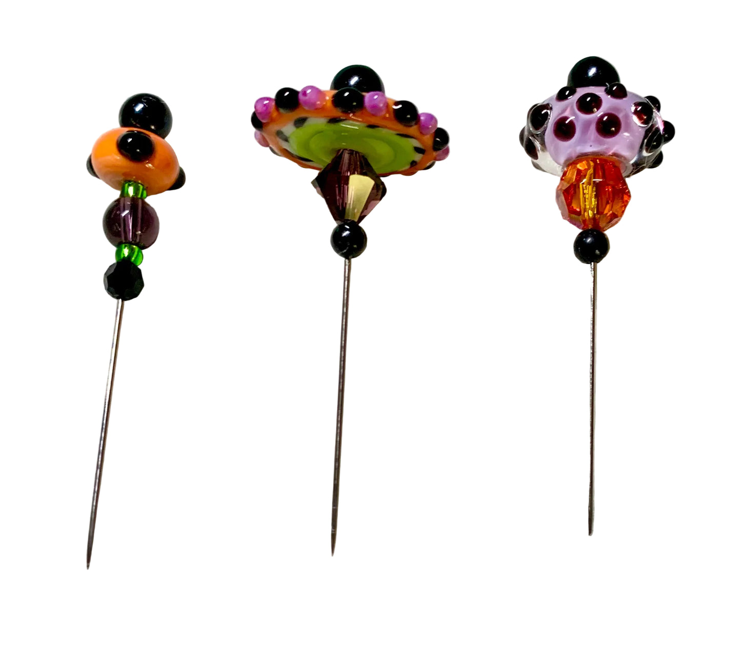 Three decorative glass pinback pins with colorful beadwork and floral tops, displayed on a white background.
[additional_image_link]