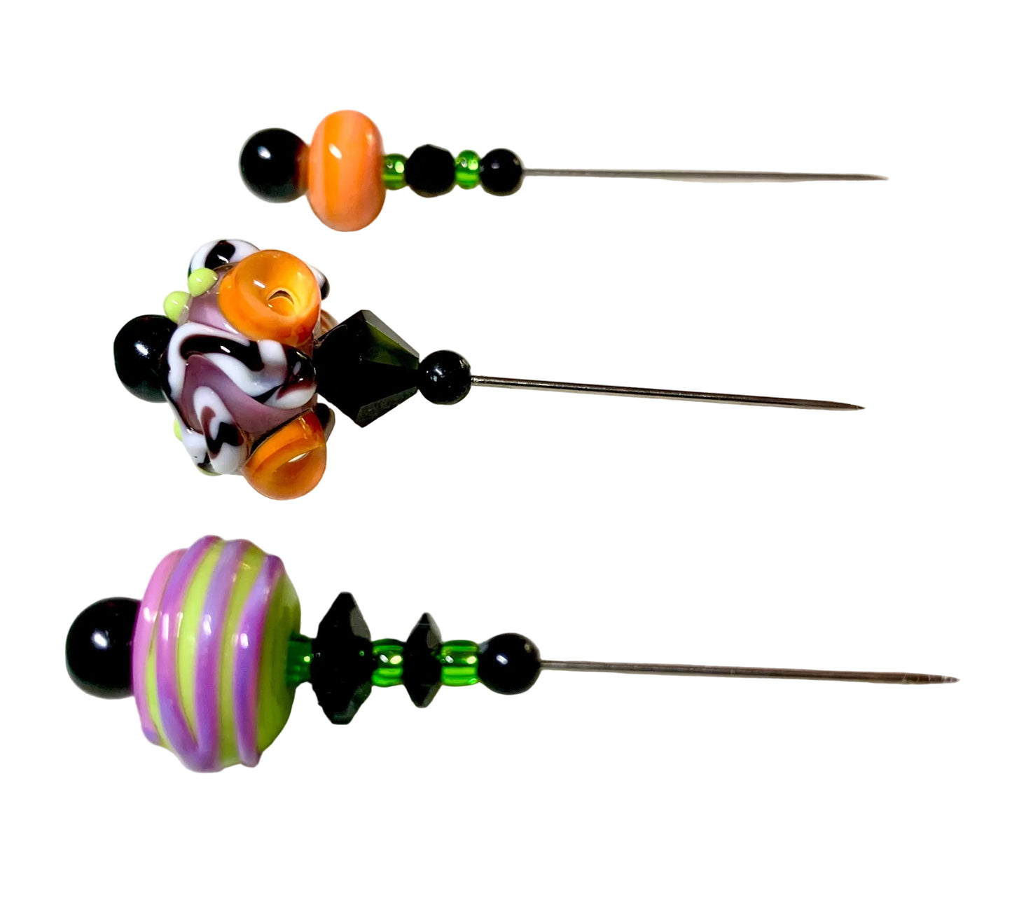 Three handmade beaded pins with unique lampwork beads, displayed on a white.
[additional_image_link]