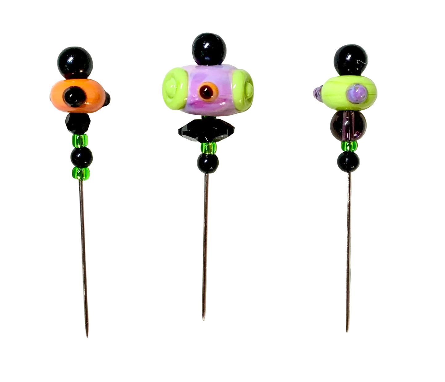 Three handmade glass bead pins with long metal needles, decorated with colorful beads on a white background.
[image_link]