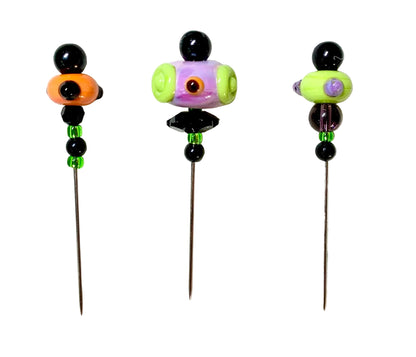 Three handmade glass bead pins with long metal needles, decorated with colorful beads on a white background.
[image_link]