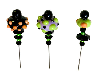 Three handmade beaded pins with black metal needles, featuring colorful glass beads on a white background.
[additional_image_link]