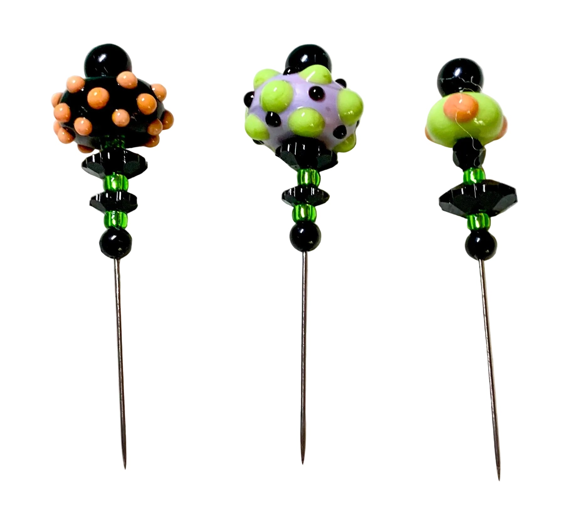 Three handmade beaded pins with long metal needles, featuring colorful glass beads and black accents on a white background.
[additional_image_link]