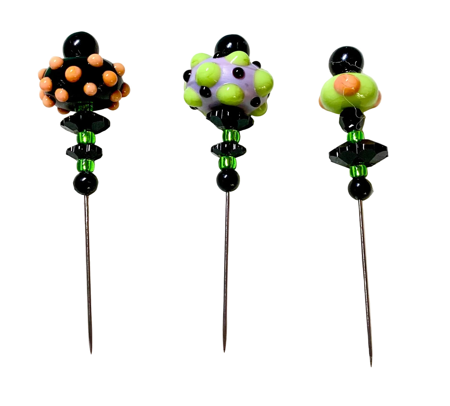 Three handmade glass bead pins with long metal needles, decorated with colorful glass beads and black faceted beads, displayed on a white background.
[additional_image_link]