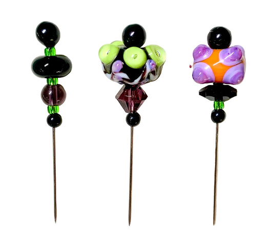 Three decorative glass sewing pins with colorful lampwork beads and black beads, displayed on a white background.
[image_link]