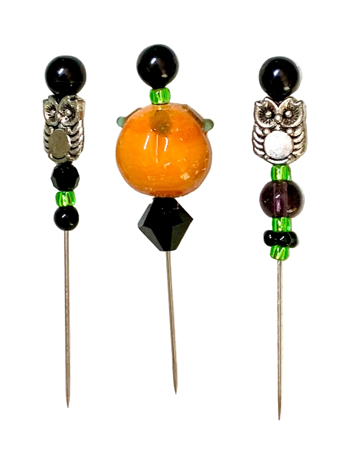 Three decorative beaded pins with owl charms and a lampwork pumpkin, displayed on a white background.
[additional_image_link]