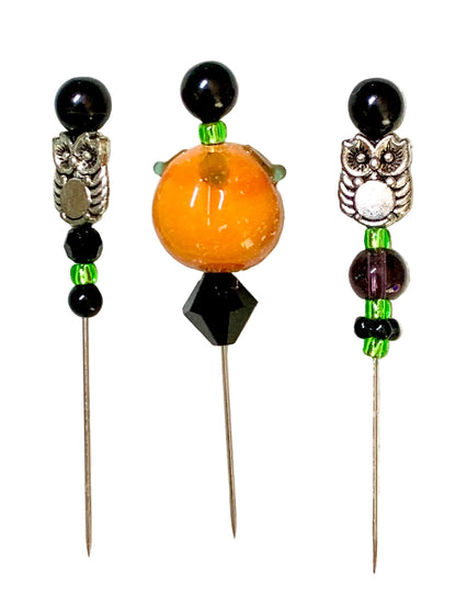 Three decorative sewing or embroidery pins with owl motifs and pumpkin bead, displayed on a white background.
[additional_image_link]