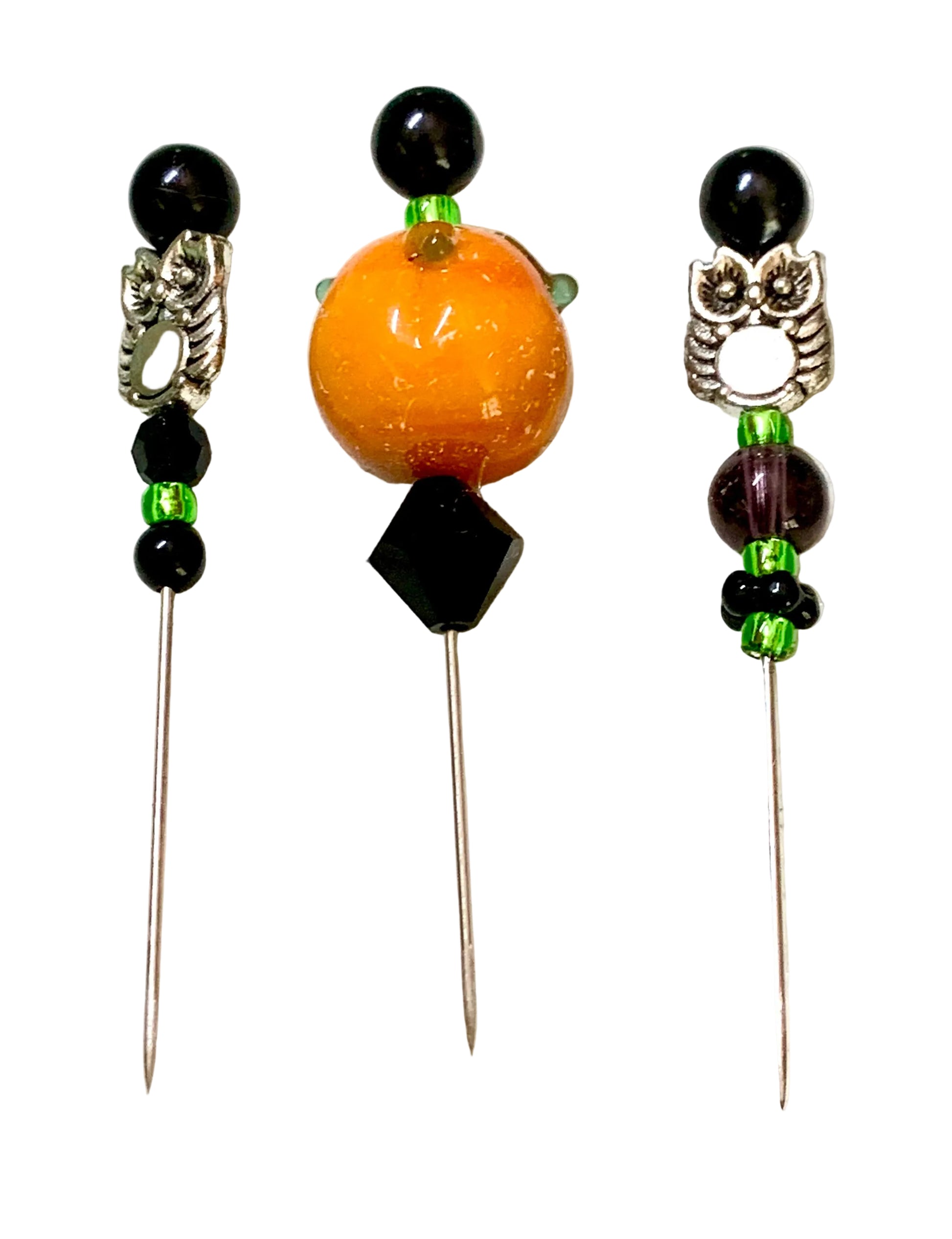 Three decorative beaded sewing needles laid flat on a white surface. The left and right pins have black beads and silver-toned metal owl details.
[additional_image_link]