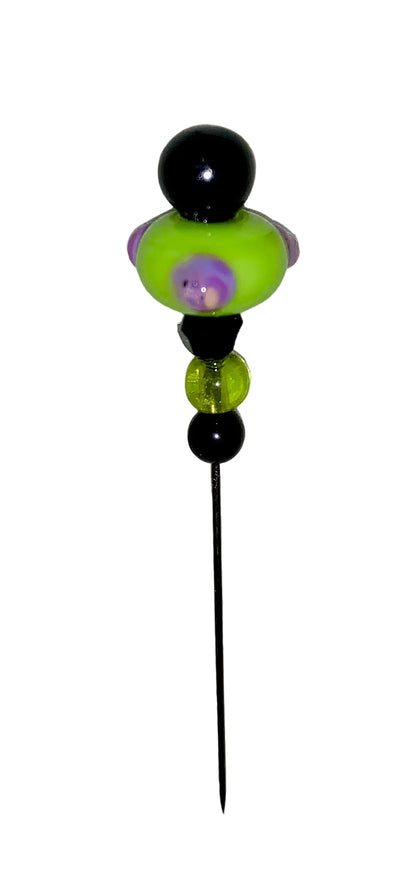 Decorative Halloween purple orange black green flower pin with colorful glass beads on a white background. 
[additional_image_link]