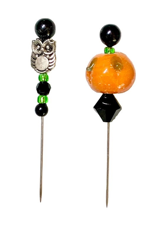 Two beaded pins displayed on a white background. One pin features a silver owl charm, black beads, and green spacer beads. The other pin is a pumpkin.
[image_link]