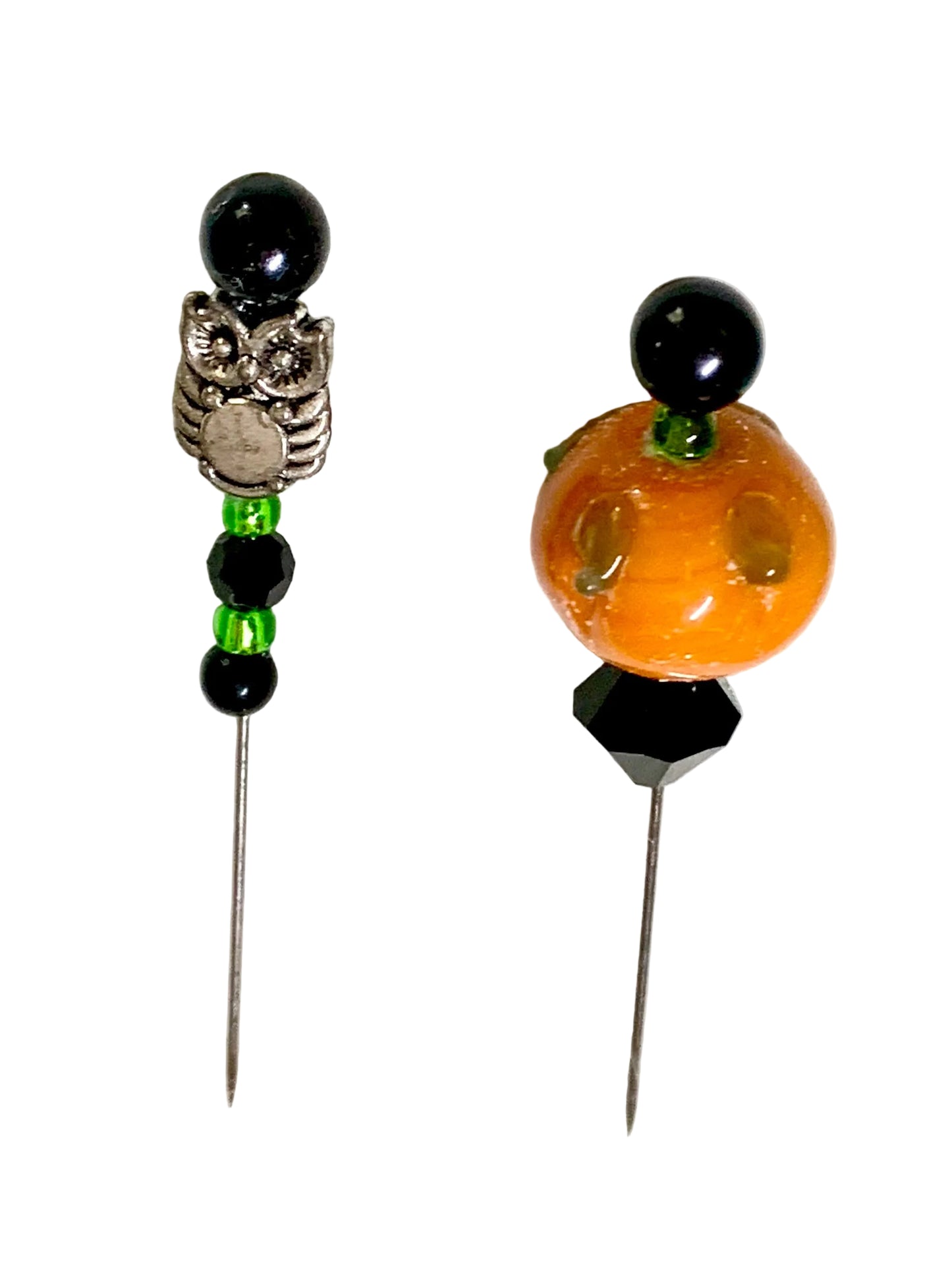 Two Halloween-themed beaded pins on a white background. One pin features a silver owl charm with black beads and green gems. The other is a pumpkin
[additional_image_link]