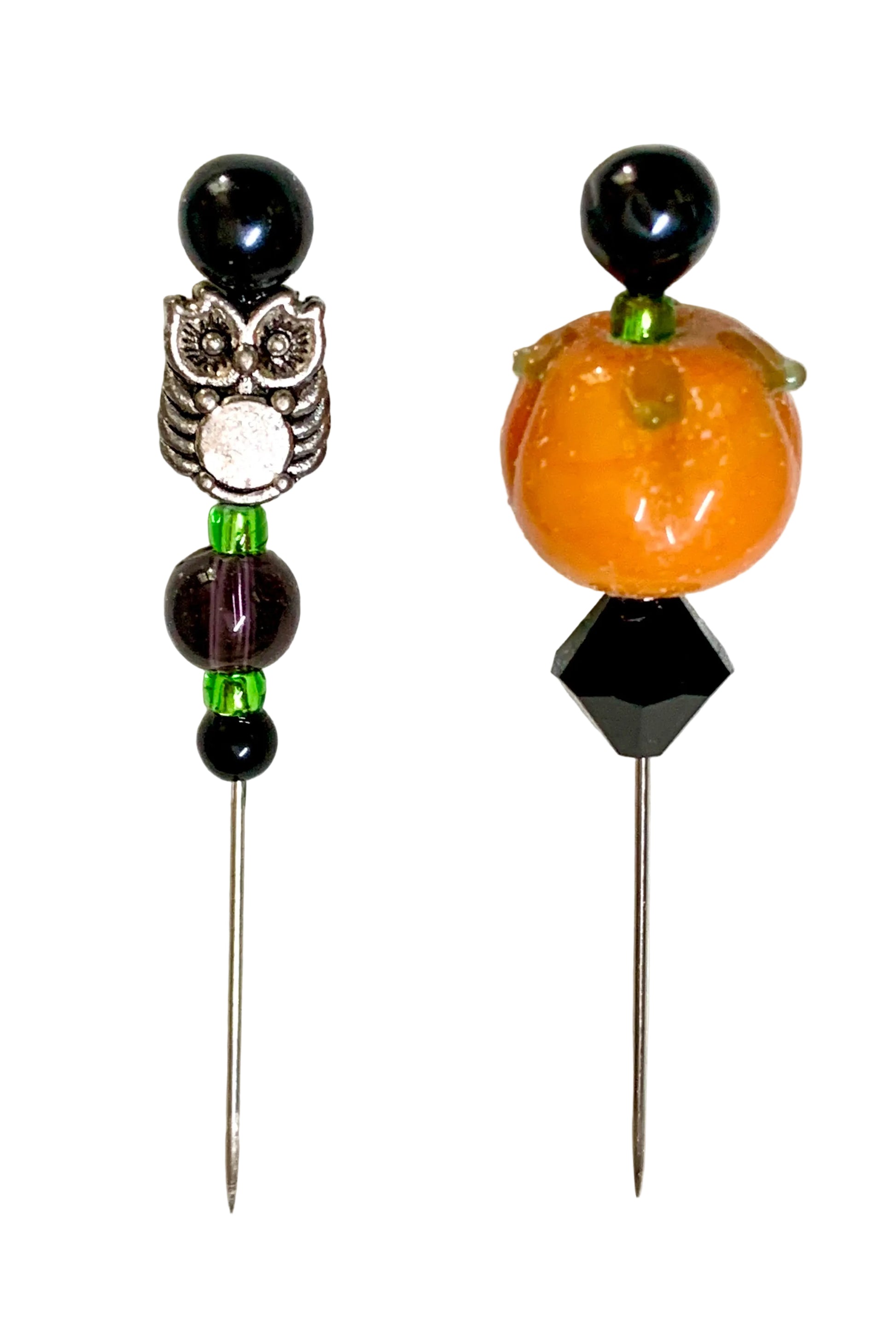 Two Halloween-themed beaded pins on a white background. One pin features a silver owl with black and white details, green beads, and black beads. The other is a pumpkin.
[additional_image_link]