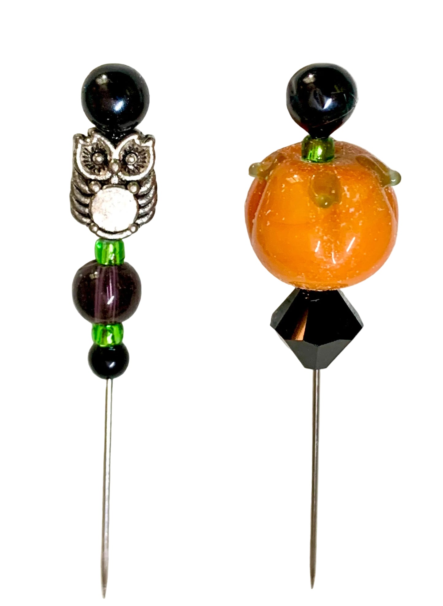 Two decorative beaded pins on a white background. One pin features a silver owl charm, black beads, and green accents. The other is a pumpkin pin.
[additional_image_link]