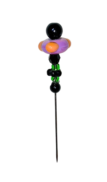 Decorative Halloween purple orange black green flower pin with colorful glass beads on a white background. 
[additional_image_link]