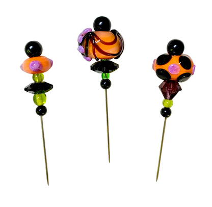 3 Decorative Halloween purple orange black green chacha pins with colorful glass beads on a white background. 
[additional_image_link]