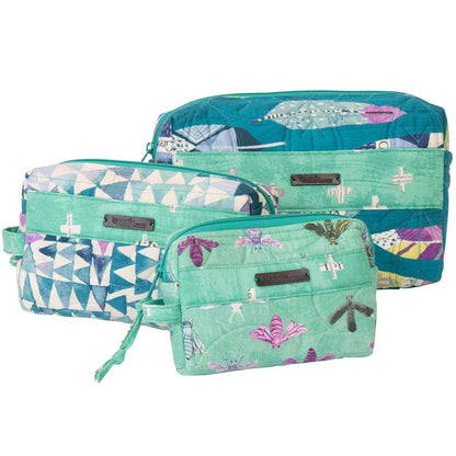 Three quilted travel pouches in a matching teal and mint green butterfly print set, including a large duffel bag, a medium zippered pouch, and a small wristlet, shown on a white background.
Photo by Annie [additional_image_link]