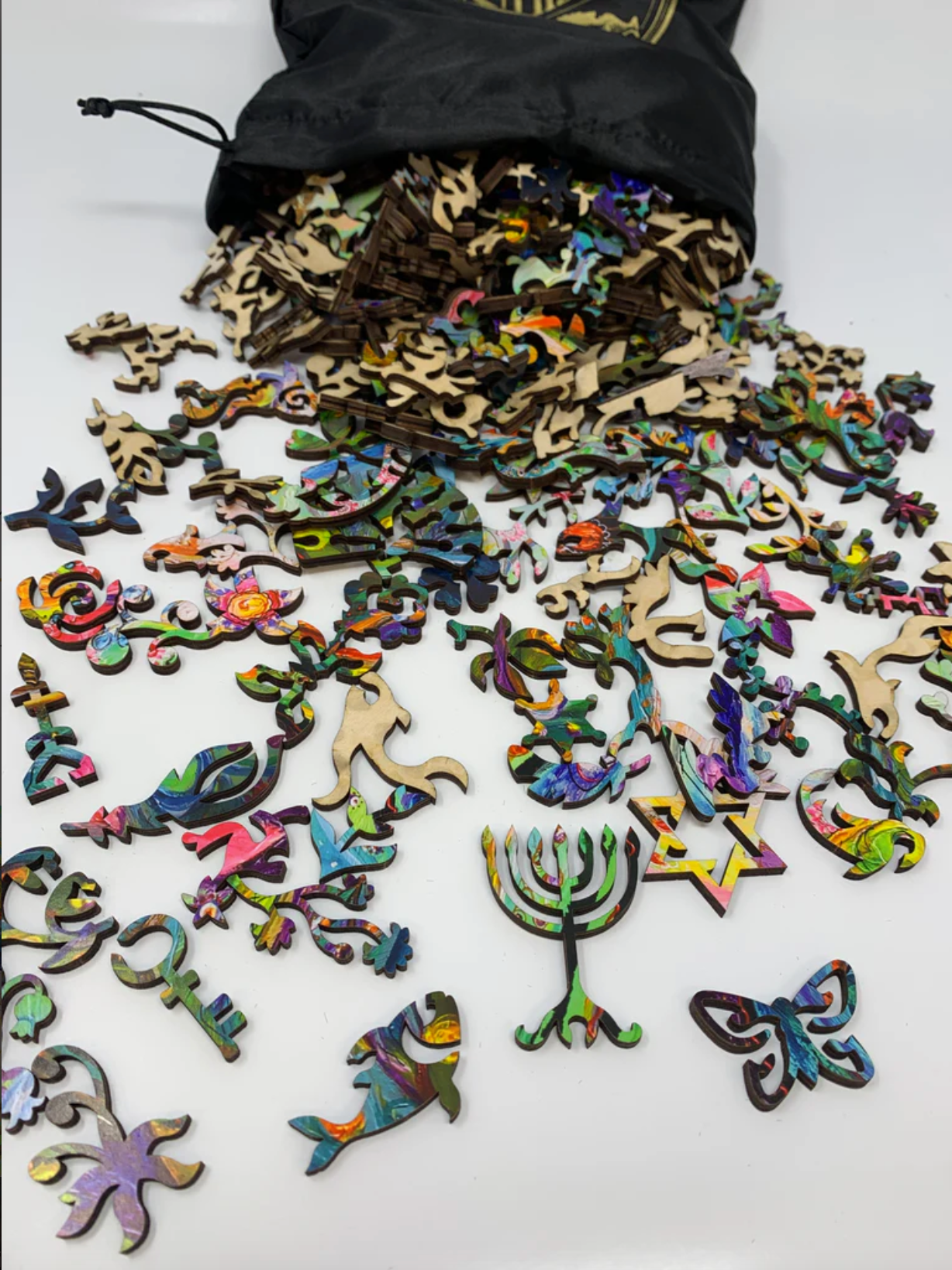 A colorful, highly detailed jigsaw puzzle featuring a stylized snake and a peacock in an intricate, patterned design.
Photo by Nautilus Puzzles [additional_image_link]