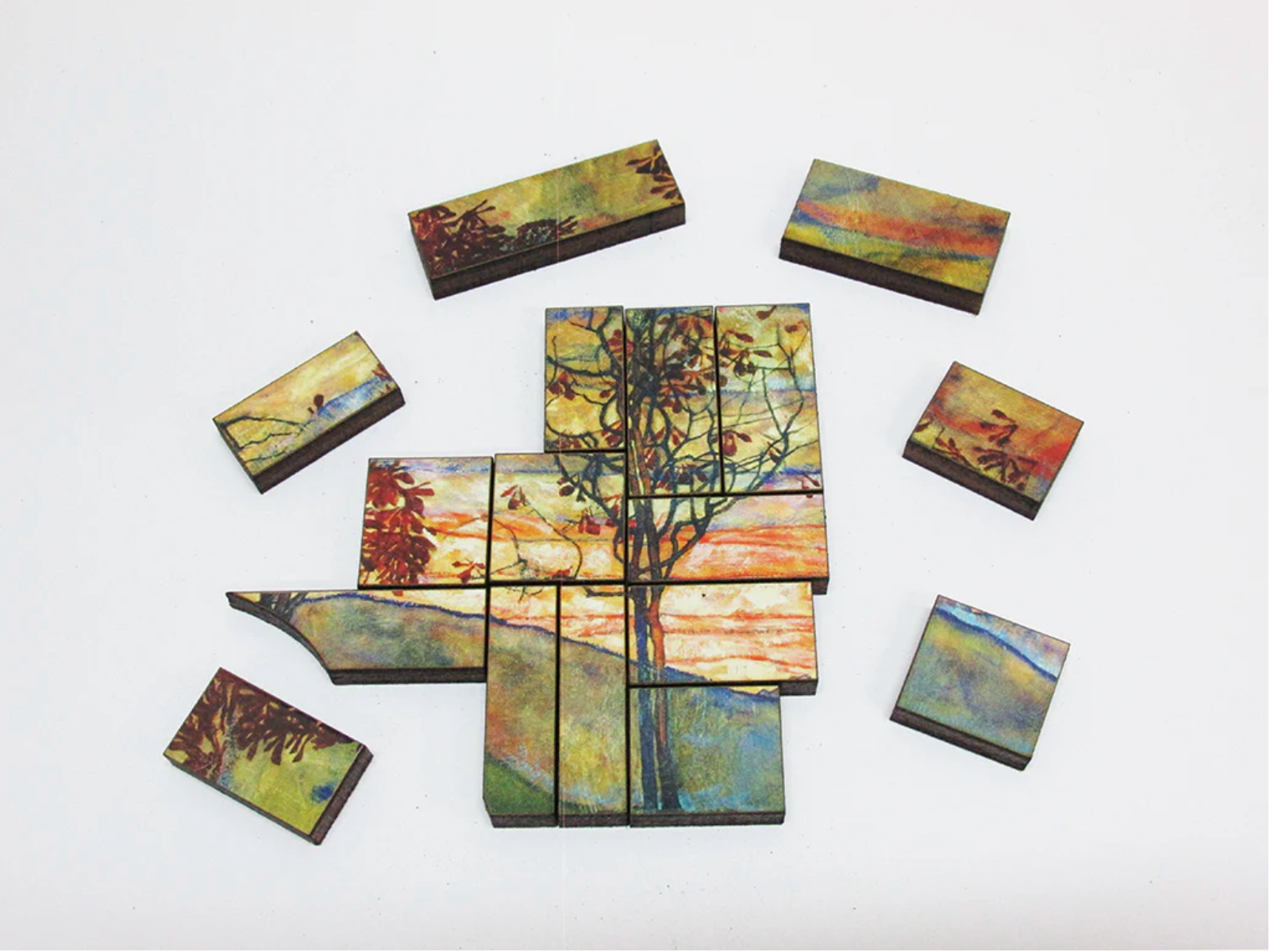A jigsaw puzzle depicting a vibrant painting of four trees against a sunset background, with a cloudy sky in the background.
Photo by Artifact Puzzles [additional_image_link]