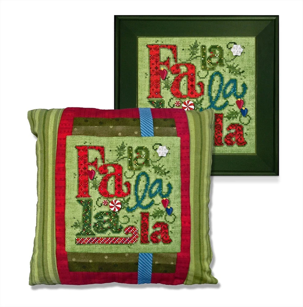 Two framed decorative pillows shown on a white background, one in front of the other. The front pillow is unframed and shows a festive patchwork design with the words 'Fa la la la' in red and teal script on a light green background, bordered by red and olive green panels with a blue stripe.
Photo by JustAnotherButtonCompany.com [image_link]