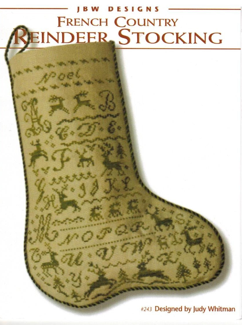 A vintage-style pattern cover for a French Country Reindeer Stocking design by JBW Designs, showing a beige embroidered stocking with dark brown stitched letters, reindeer motifs, and decorative borders on a white background.
Photo by JBW Designs [additional_image_link]