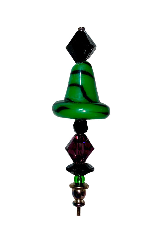 Decorative green witch hat stick pin with green and purple beads on a white background.
[image_link]