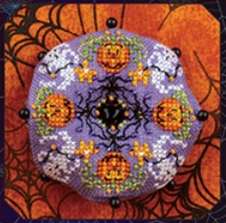 A square decorative pillow with a Halloween theme, featuring embroidered or beadwork-style designs of orange pumpkins, black spiderwebs, and white flowers on a lavender-purple background, set against a larger orange spiderweb pattern.
Photo by JustNan.com [additional_image_link]