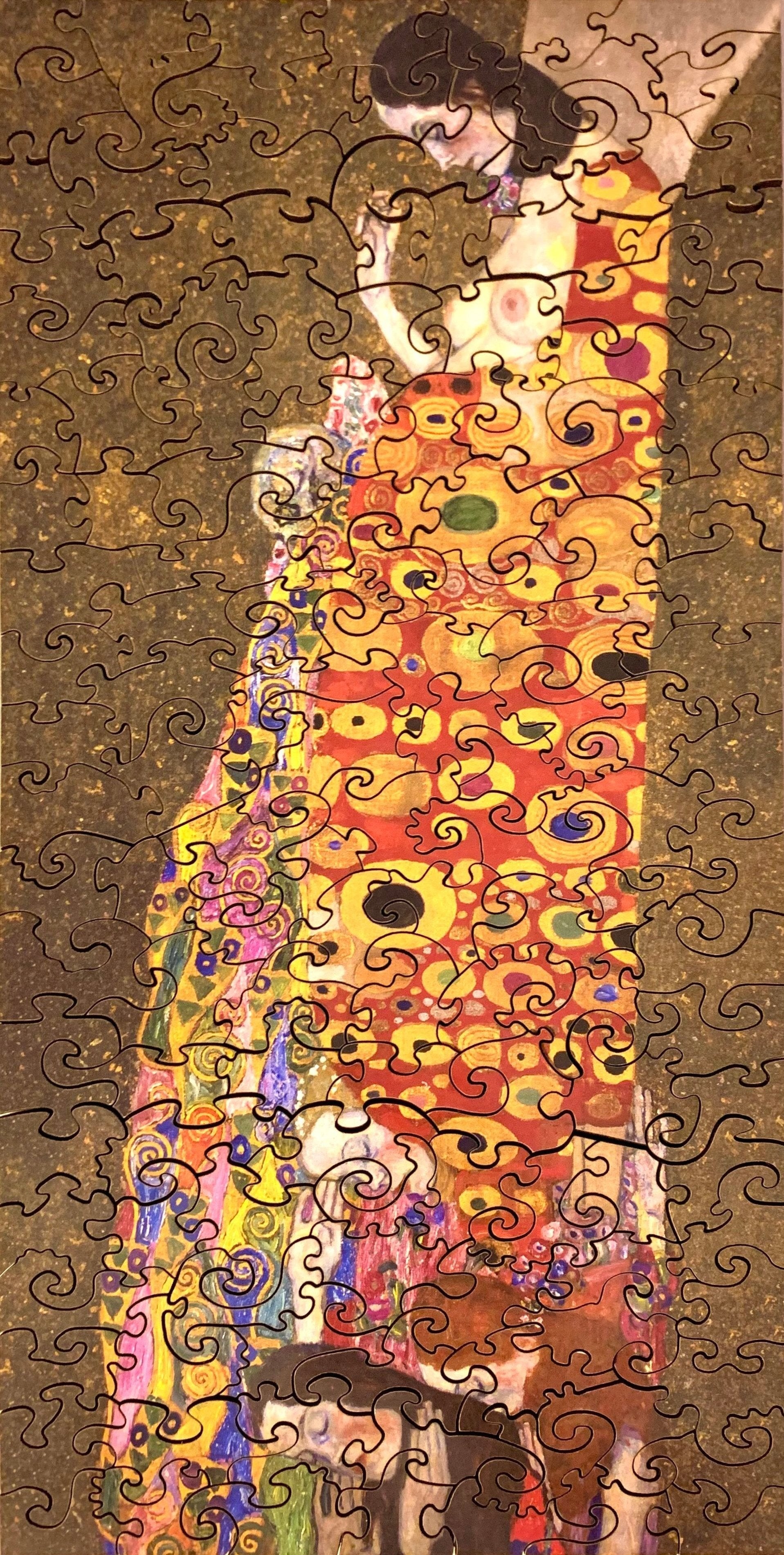 A jigsaw puzzle featuring a colorful artistic design, a depiction of a pregnant female figure with ornate details and a vibrant backdrop.
Photo by Karen King [additional_image_link]