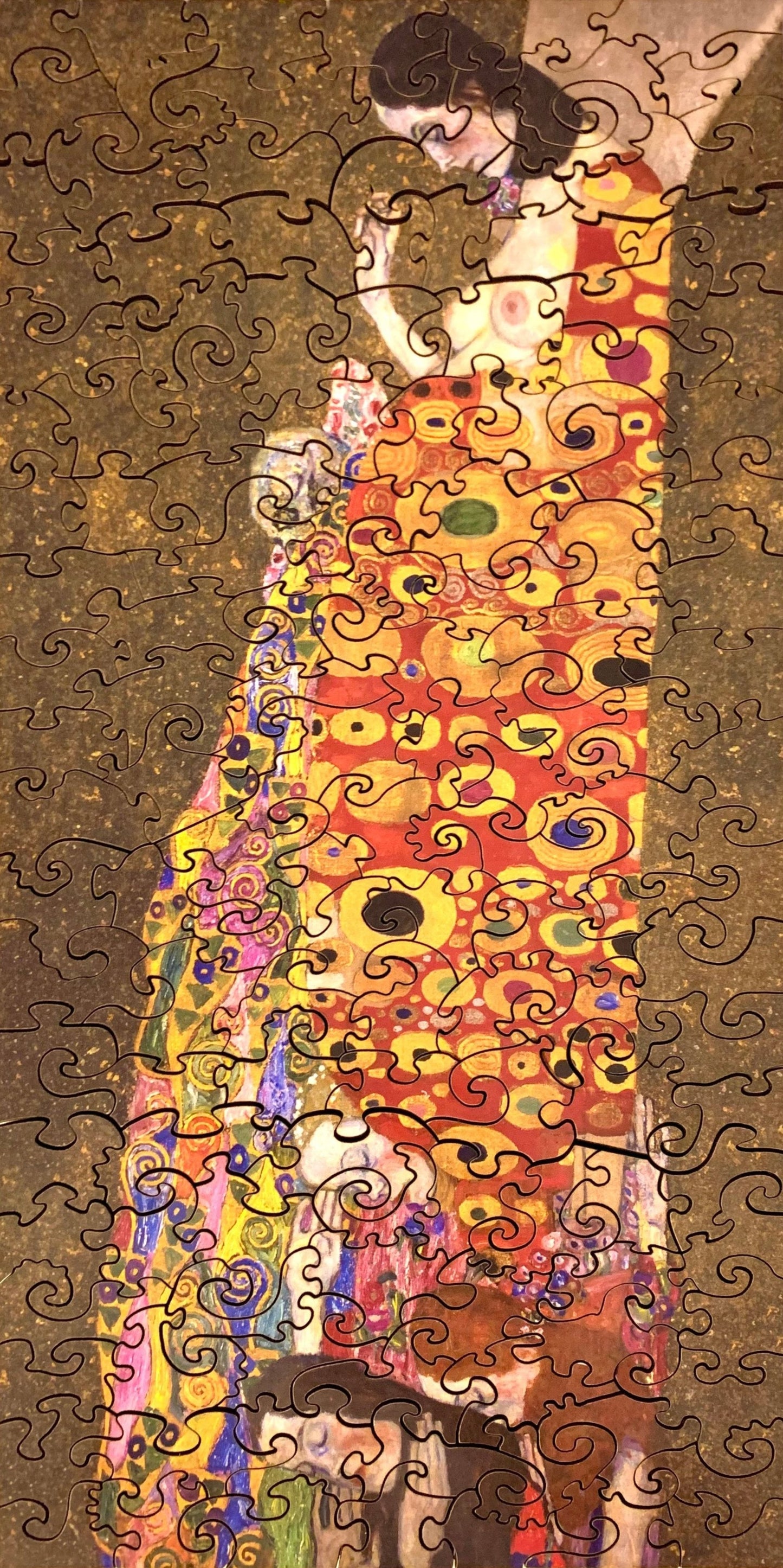 A jigsaw puzzle featuring a colorful artistic design, a depiction of a pregnant female figure with ornate details and a vibrant backdrop.
Photo by Karen King [additional_image_link]