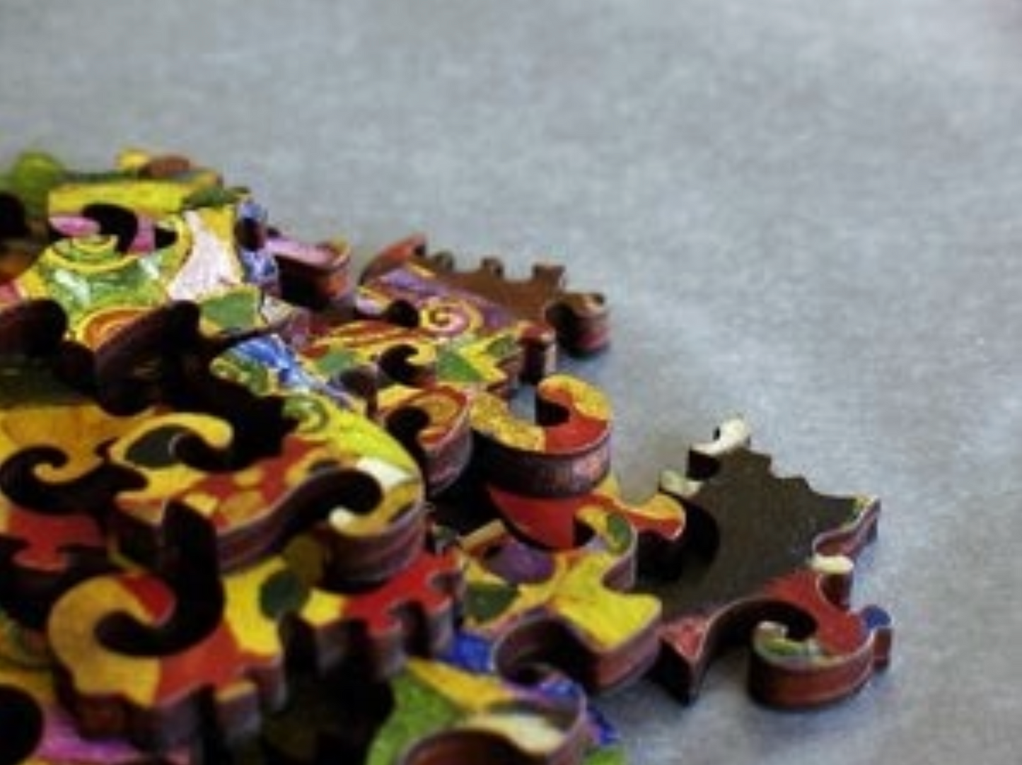 A jigsaw puzzle featuring a colorful artistic design, a depiction of a pregnant female figure with ornate details and a vibrant backdrop.
Photo by Artifact Puzzles [additional_image_link]