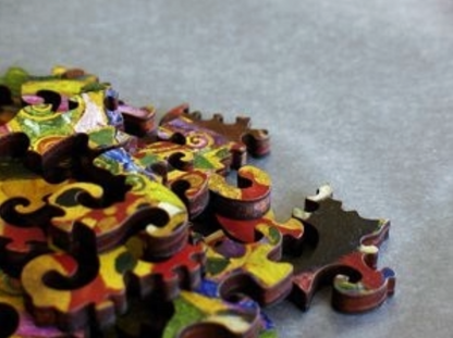 A jigsaw puzzle featuring a colorful artistic design, a depiction of a pregnant female figure with ornate details and a vibrant backdrop.
Photo by Artifact Puzzles [additional_image_link]