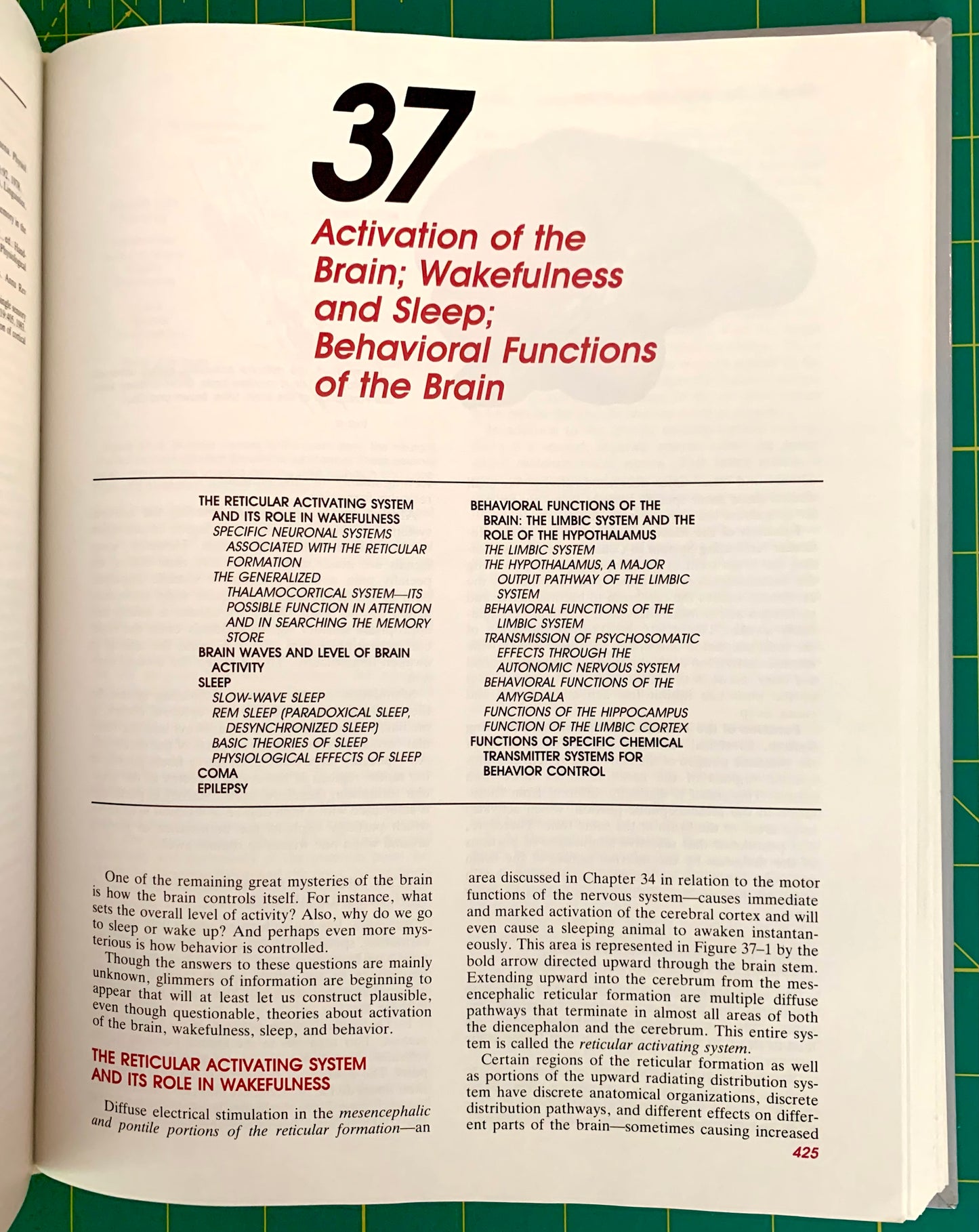 An open book showing a printed page with the large black number 37 and red and black text titled 'Activation of the Brain: Wakefulness and Sleep; Behavioral Functions of the Brain.' The page is photographed against a green background.
[additional_image_link]