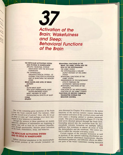An open book showing a printed page with the large black number 37 and red and black text titled 'Activation of the Brain: Wakefulness and Sleep; Behavioral Functions of the Brain.' The page is photographed against a green background.
[additional_image_link]